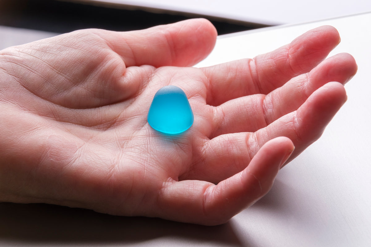 A Dentablue gummy in the palm of a hand